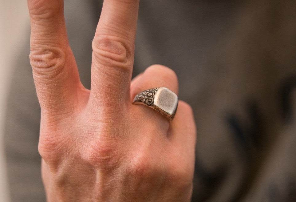 Man's hand with signet ring